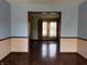 Bright living room features hardwood floors and a doorway into another room with natural light from a window at 8122 Tanager Ct, Indianapolis, IN 46256