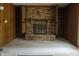 Spacious living room with wood paneling and a brick fireplace that includes built-in bookshelves at 8122 Tanager Ct, Indianapolis, IN 46256