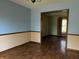 Spacious living room features hardwood floors and doorway into another room with light from a window at 8122 Tanager Ct, Indianapolis, IN 46256