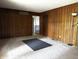 Spacious living room with wood paneling and carpeted floors at 8122 Tanager Ct, Indianapolis, IN 46256