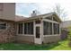 The sunroom is attached to the home's exterior, providing a tranquil space with natural lighting at 8122 Tanager Ct, Indianapolis, IN 46256