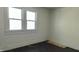 A bedroom featuring white walls, wood floors, and a window bringing in natural light at 822 N Bradley Ave, Indianapolis, IN 46201