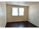 Neutral bedroom with a bright window and hardwood floors providing a serene space for rest and rejuvenation at 822 N Bradley Ave, Indianapolis, IN 46201
