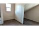 Bedroom featuring white walls and wood-style carpet at 822 N Bradley Ave, Indianapolis, IN 46201