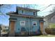 Side view of a residential duplex showcasing light blue siding and an inviting backyard, with potential for outdoor enjoyment at 822 N Bradley Ave, Indianapolis, IN 46201