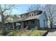 A quaint duplex featuring a covered front porch, showcasing its classic architectural style and inviting curb appeal at 822 N Bradley Ave, Indianapolis, IN 46201