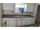 Outdated kitchen featuring wood cabinets, a stainless steel sink, and a window at 822 N Bradley Ave, Indianapolis, IN 46201
