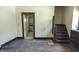 Living room with wood floors, stairs, and view to the kitchen through a door frame at 822 N Bradley Ave, Indianapolis, IN 46201