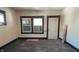 The living room features an exterior door, windows, and wood trim and floors at 822 N Bradley Ave, Indianapolis, IN 46201