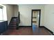 Classic interior showcasing hardwood floors, an adjacent staircase, and an entryway view to a kitchen area at 822 N Bradley Ave, Indianapolis, IN 46201