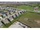 An aerial view of new construction homes shows a golf course, pond and nearby green space at 8442 Averly Park Dr, Indianapolis, IN 46237