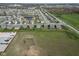 This aerial view shows new homes along a pond and next to green space and a neighborhood at 8442 Averly Park Dr, Indianapolis, IN 46237