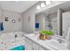 Bathroom featuring double sink vanity, garden tub, glass enclosed shower, and decorative wall art at 8442 Averly Park Dr, Indianapolis, IN 46237