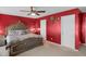 Bedroom featuring plush carpeting, ceiling fan, a decorative wall, and furnishings at 8442 Averly Park Dr, Indianapolis, IN 46237