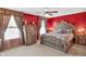 Bedroom with ornate bed frame, luxurious decor, plush carpeting, and natural light from two windows at 8442 Averly Park Dr, Indianapolis, IN 46237
