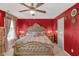 Bedroom with a decorative wall, bedside lamps, ornate headboard, and a ceiling fan at 8442 Averly Park Dr, Indianapolis, IN 46237