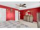 Bedroom featuring ceiling fan, large dresser, decorative wall, and a peek into the connected bathroom at 8442 Averly Park Dr, Indianapolis, IN 46237