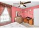 Bedroom featuring large window, decor, ceiling fan, desk, dresser and a bed with a patterned comforter at 8442 Averly Park Dr, Indianapolis, IN 46237