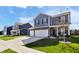 Charming two-story home showcasing a well-maintained lawn, wide driveway, and attached two-car garage at 8442 Averly Park Dr, Indianapolis, IN 46237