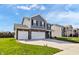 Well-manicured home featuring a two-car garage, appealing facade, and manicured front lawn at 8442 Averly Park Dr, Indianapolis, IN 46237