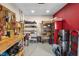 Organized garage with pegboard, metal racks, workbench, storage for tools, equipment, and supplies at 8442 Averly Park Dr, Indianapolis, IN 46237
