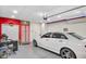 Finished garage with a modern aesthetic, featuring an epoxy floor, car, desk, and smart home features at 8442 Averly Park Dr, Indianapolis, IN 46237