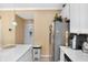 Kitchen area featuring stainless steel fridge and access door to another room at 8442 Averly Park Dr, Indianapolis, IN 46237