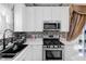 Modern kitchen boasts stainless steel appliances, sleek countertops, and natural light at 8442 Averly Park Dr, Indianapolis, IN 46237