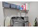 Laundry room including washing machine, dryer, storage baskets, shelving, cleaning supplies, ironing board at 8442 Averly Park Dr, Indianapolis, IN 46237