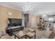 Open-concept living room featuring a stylish chandelier and modern fireplace at 8442 Averly Park Dr, Indianapolis, IN 46237
