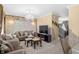 Bright living area with plush seating, elegant decor, and a mounted TV, creating a welcoming and stylish entertainment space at 8442 Averly Park Dr, Indianapolis, IN 46237