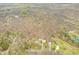 Aerial view showcasing the home's setting nestled among trees, with nearby roads and a small, shimmering pond at 8503 Bean Blossom Rd, Trafalgar, IN 46181