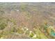 Expansive aerial view of the property featuring a barn, house, surrounded by lush greenery and a serene pond at 8503 Bean Blossom Rd, Trafalgar, IN 46181