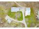 Aerial view of multiple buildings featuring metal roofs, driveway, and surrounding greenery at 8503 Bean Blossom Rd, Trafalgar, IN 46181
