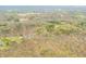 An aerial perspective reveals a home surrounded by a vast, verdant landscape punctuated by trees and quiet roads at 8503 Bean Blossom Rd, Trafalgar, IN 46181
