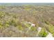 An aerial view showcasing the property with mature trees in a tranquil, wooded setting at 8503 Bean Blossom Rd, Trafalgar, IN 46181