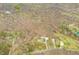 Property's aerial view featuring a home, barn, and verdant landscape with interspersed trees and a nearby road network at 8503 Bean Blossom Rd, Trafalgar, IN 46181