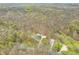 Aerial shot showcasing the property and surrounding area including woods, homes, and roads at 8503 Bean Blossom Rd, Trafalgar, IN 46181