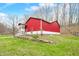 Charming barn with white trim, complemented by a neatly landscaped yard and driveway at 8503 Bean Blossom Rd, Trafalgar, IN 46181