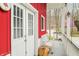 Barn porch featuring double doors, a bench, and a tranquil view of the surrounding greenery at 8503 Bean Blossom Rd, Trafalgar, IN 46181