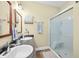 Bathroom featuring a double sink, shower with glass door, and modern fixtures at 8503 Bean Blossom Rd, Trafalgar, IN 46181