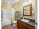 Bathroom vanity and tub with shower at 8503 Bean Blossom Rd, Trafalgar, IN 46181