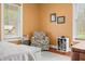Cozy bedroom features a window, floral chair, and hardwood floors at 8503 Bean Blossom Rd, Trafalgar, IN 46181