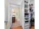 Walk-in closet with built in shelving and door leading to bathroom at 8503 Bean Blossom Rd, Trafalgar, IN 46181