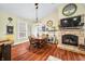 Inviting dining area featuring a fireplace and wood floors, creating a cozy atmosphere at 8503 Bean Blossom Rd, Trafalgar, IN 46181