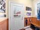 Practical entryway with wainscoting, bench, and hooks, providing a functional and welcoming space at 8503 Bean Blossom Rd, Trafalgar, IN 46181