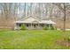 Beautiful home with a welcoming front porch and well-manicured lawn at 8503 Bean Blossom Rd, Trafalgar, IN 46181