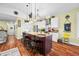 Kitchen island with dark wood cabinets, sink, barstool seating, and stainless steel appliances at 8503 Bean Blossom Rd, Trafalgar, IN 46181