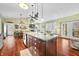 View of the kitchen island with stone countertops, pendant lighting, sink and faucet at 8503 Bean Blossom Rd, Trafalgar, IN 46181