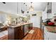Kitchen island with barstool seating, sink, dishwasher, and stainless steel appliances at 8503 Bean Blossom Rd, Trafalgar, IN 46181